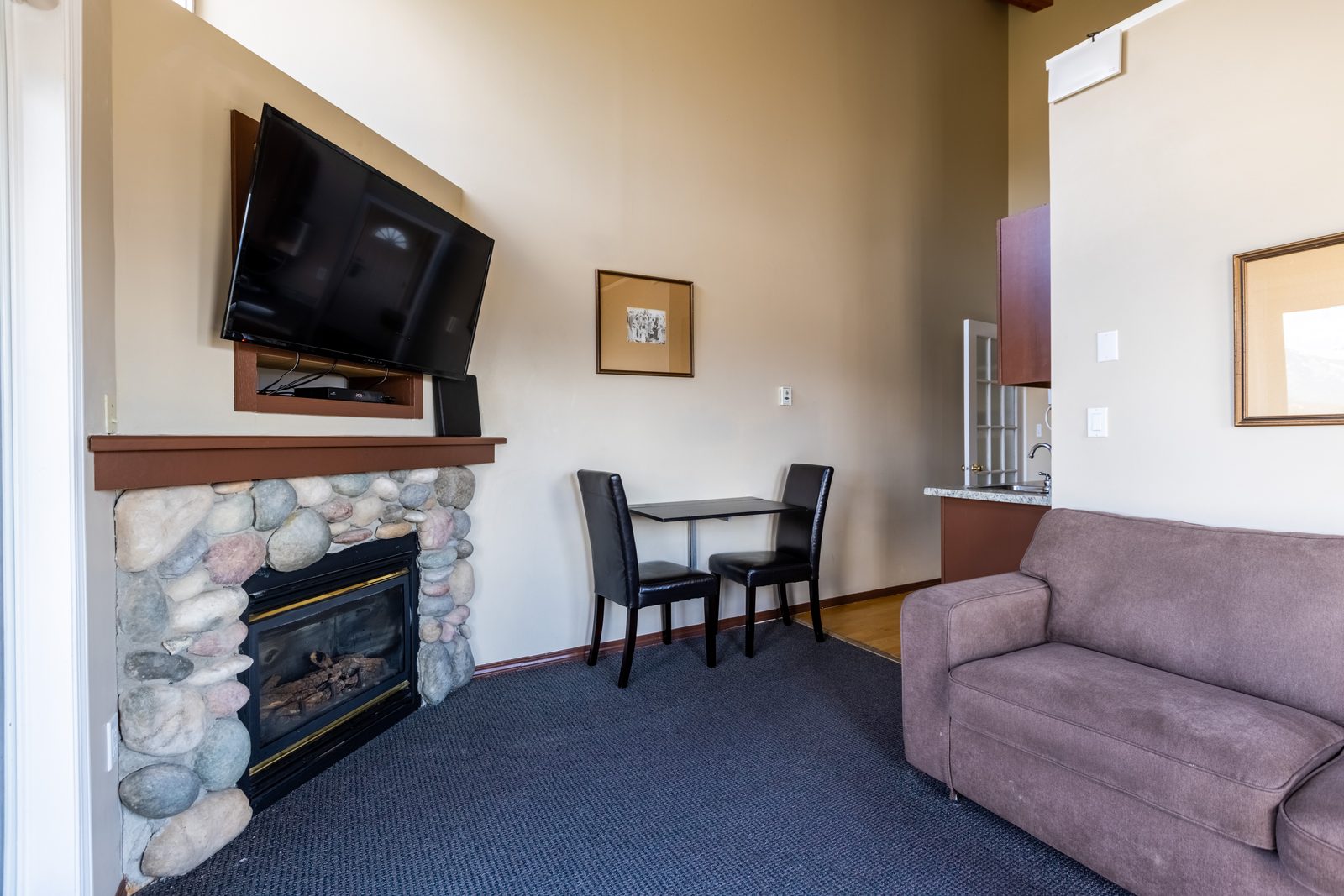Main Floor Queen Suite sitting area with propane fireplace